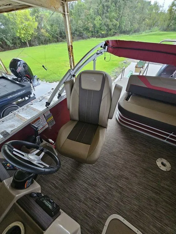 Slide: The Image of 2021 Bennington 22 SSBX boat interior with steering wheel and seating. - 30