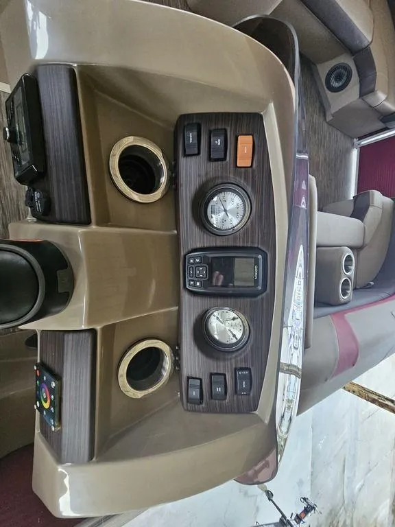 Slide: The Image of 2021 Bennington 22 SSBX boat dashboard with gauges and controls. - 31