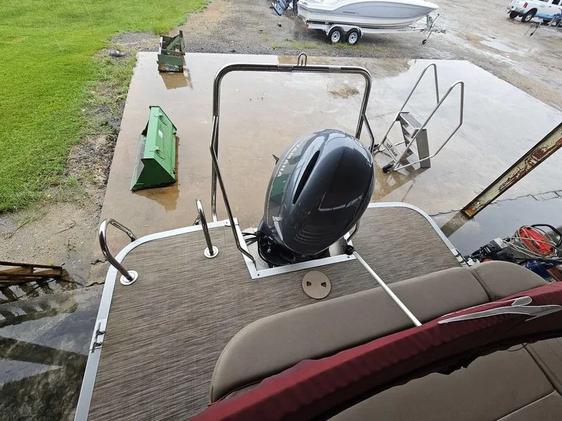 Slide: The Image of 2021 Bennington 22 SSBX pontoon boat with outboard motor, docked on wet surface. - 33