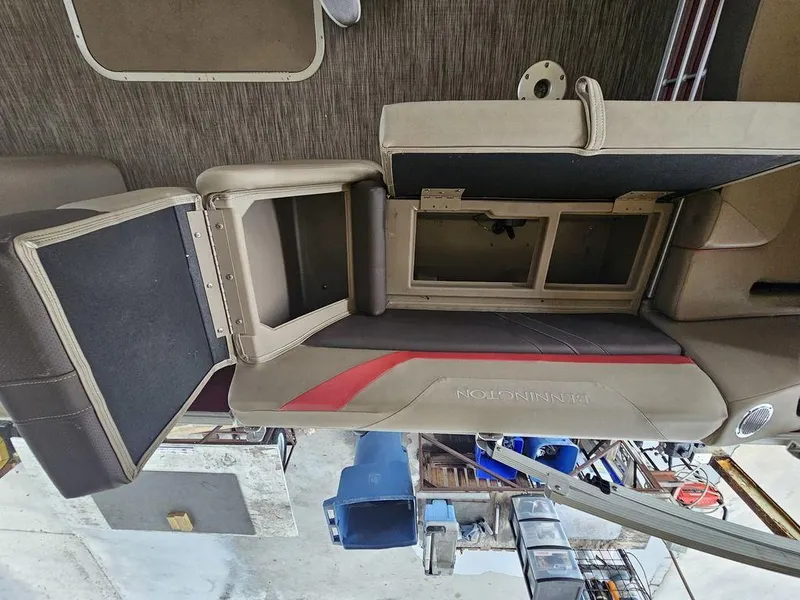 Slide: The Image of 2021 Bennington 22 SSBX boat interior with open storage compartments and seating. - 36