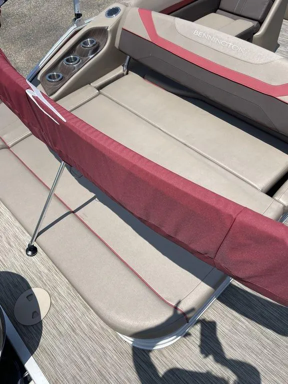 Slide: The Image of 2021 Bennington 22 SSBX boat interior with red and beige seating. - 6