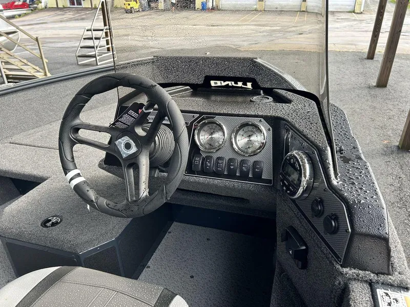 Slide: The Image of 2025 Lund ADVENTURE 1675 SS boat dashboard with steering wheel and instrument panel. - 5