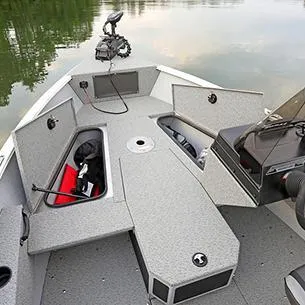 Slide: The Image of 2025 Lund ADVENTURE 1675 SS boat interior with storage compartments open on calm water. - 9