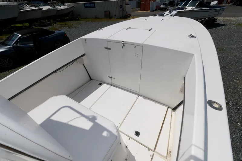 Slide: The Image of 1994 Contender 25 Tournament boat deck, spacious and clean, in a marina setting. - 10