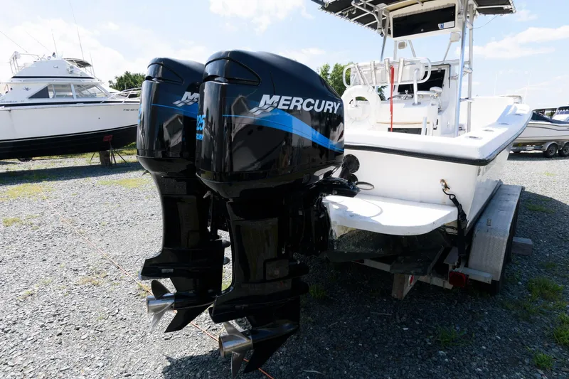 Slide: The Image of 1994 Contender 25 Tournament boat with dual Mercury outboard engines on a trailer. - 13