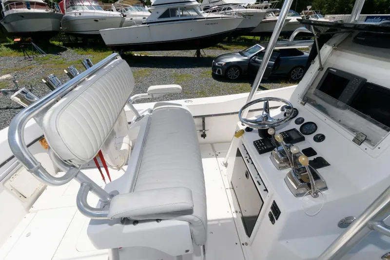 Slide: The Image of 1994 Contender 25 Tournament boat interior with steering wheel and controls. - 4