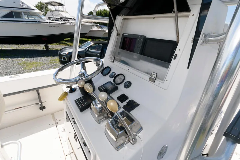 Slide: The Image of 1994 Contender 25 Tournament boat dashboard with steering wheel and controls. - 5