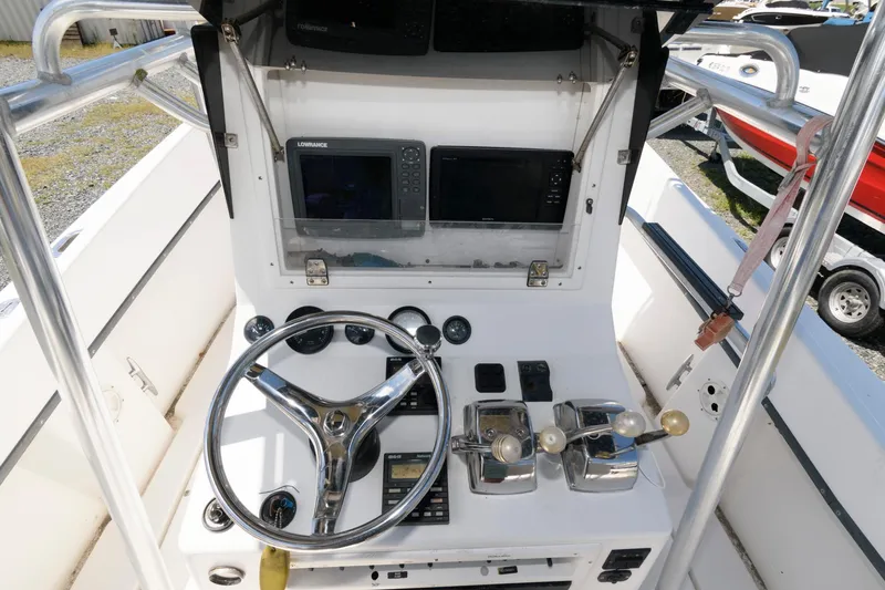 Slide: The Image of 1994 Contender 25 Tournament boat console with steering wheel, controls, and navigation equipment. - 6