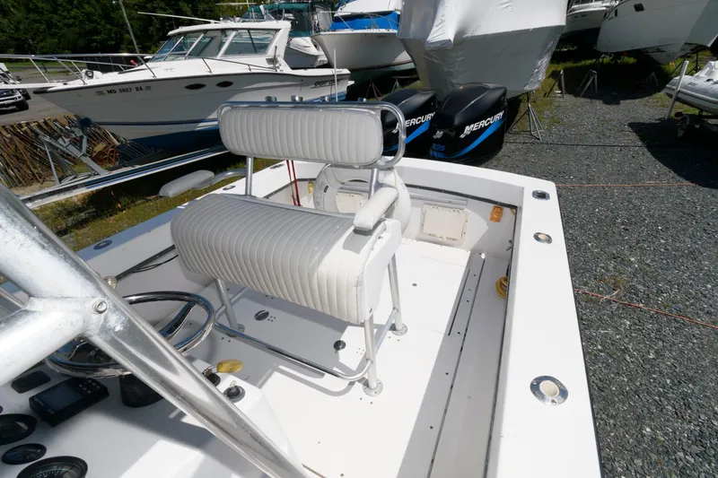 Slide: The Image of 1994 Contender 25 Tournament boat with white seating and dual Mercury engines. - 7