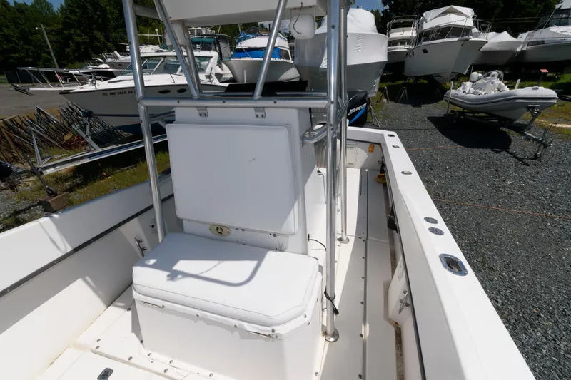 Slide: The Image of 1994 Contender 25 Tournament boat interior with seating and storage, docked among other boats. - 8
