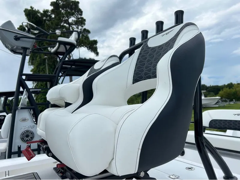 Slide: The Image of 2025 Tidewater 25 TPC Raptor boat seats with sleek black and white design. - 11