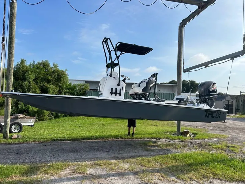 Slide: The Image of 2025 Tidewater 25 TPC Raptor boat suspended outdoors on a lift. - 15