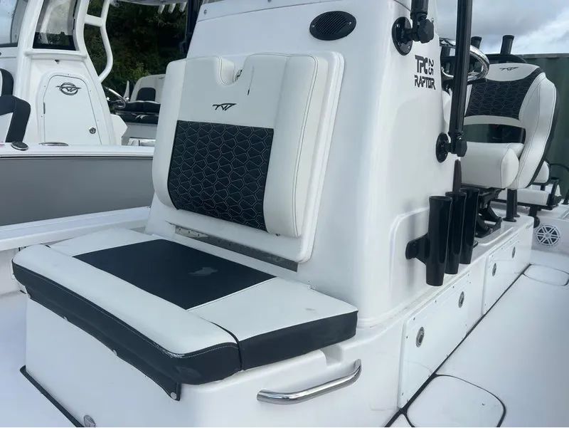 Slide: The Image of 2025 Tidewater 25 TPC Raptor boat interior with cushioned seating and rod holders. - 17