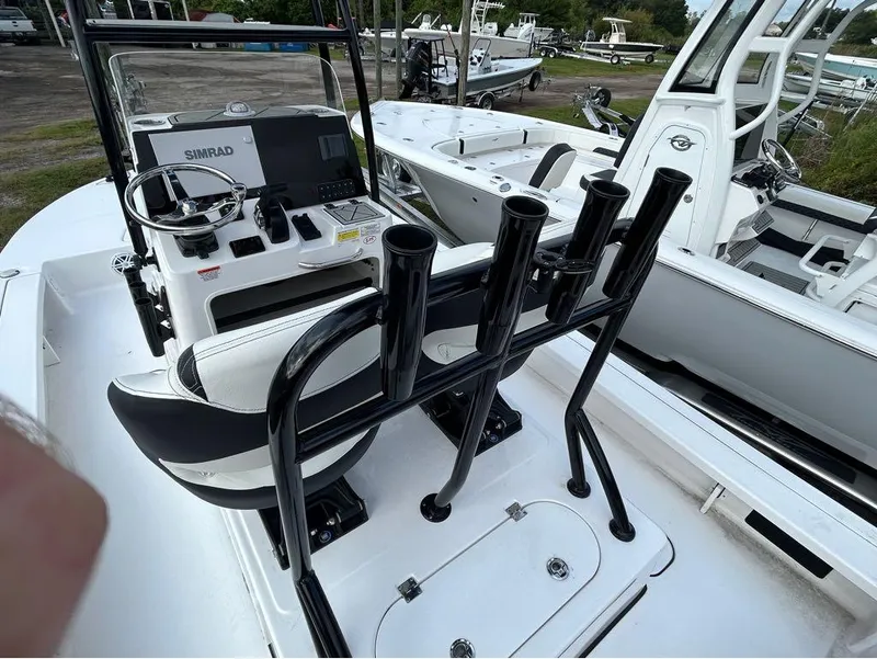 Slide: The Image of 2025 Tidewater 25 TPC Raptor boat interior with steering console and rod holders. - 19