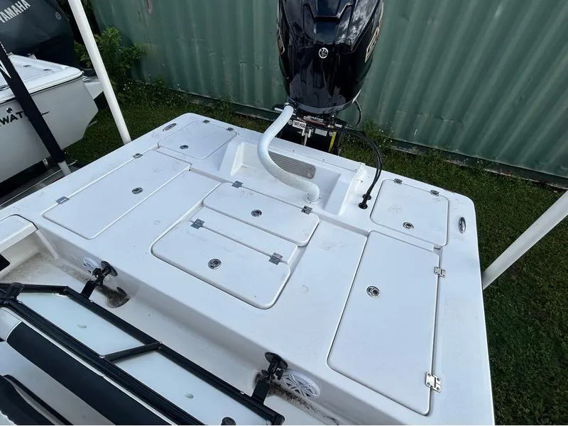 Slide: The Image of 2025 Tidewater 25 TPC Raptor boat deck with storage compartments and motor. - 20