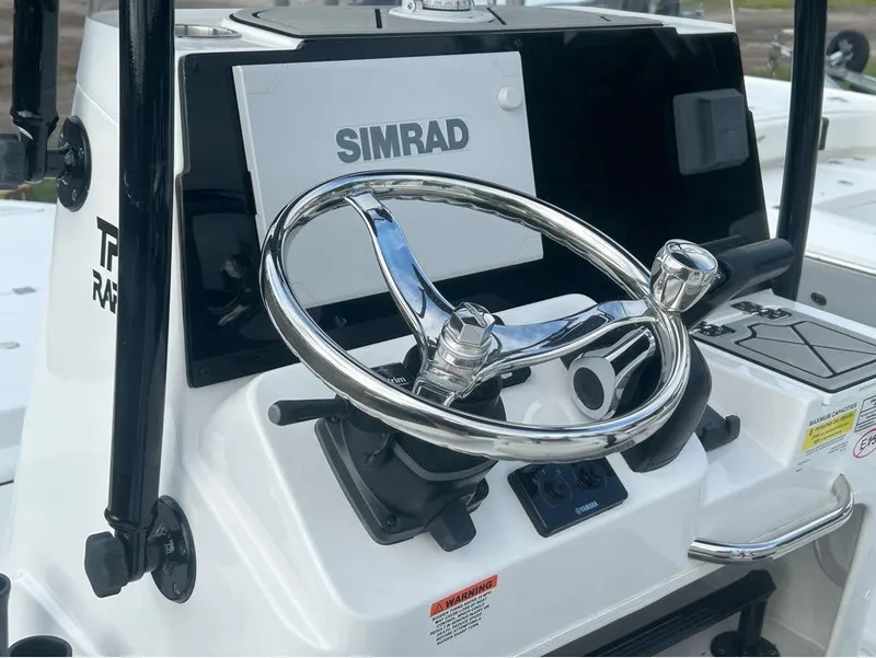 Slide: The Image of 2025 Tidewater 25 TPC Raptor boat dashboard with Simrad display and chrome steering wheel. - 21