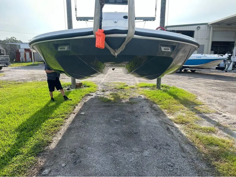 Slide: The Image of 2025 Tidewater 25 TPC Raptor boat suspended in a yard, showcasing its hull design. - 4