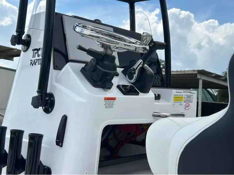 Slide: The Image of 2025 Tidewater 25 TPC Raptor boat console with steering wheel and controls. - 7