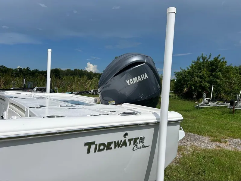 Slide: The Image of 2025 Tidewater 2500 Carolina Bay boat with Yamaha engine in grassy area. - 10