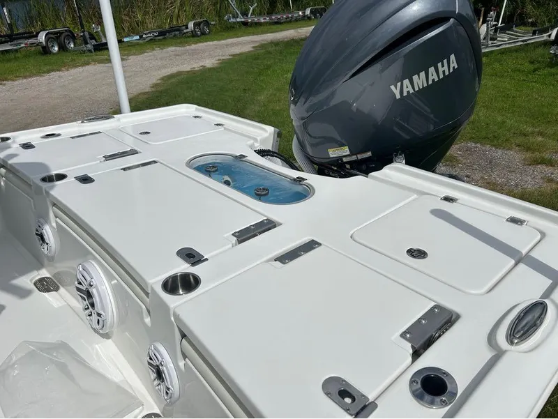 Slide: The Image of 2025 Tidewater 2500 Carolina Bay boat with Yamaha engine, featuring storage compartments and speakers. - 14