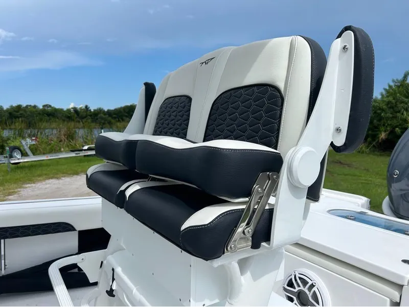 Slide: The Image of 2025 Tidewater 2500 Carolina Bay boat seating with black and white upholstery. - 2