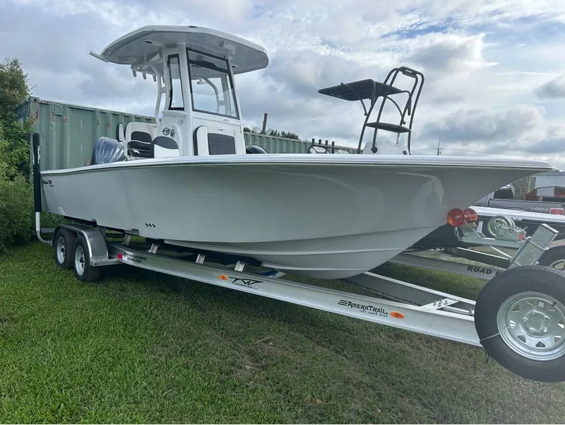 Slide: The Image of 2025 Tidewater 2500 Carolina Bay boat on trailer, parked on grass. - 8