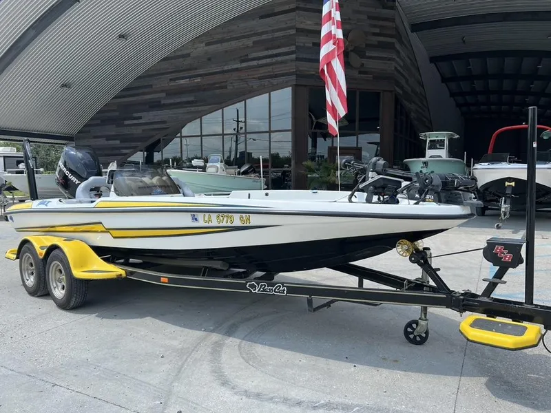 Slide: The Image of 2010 Bass Cat Boats Pantera IV on trailer, parked outside a modern building. - 10