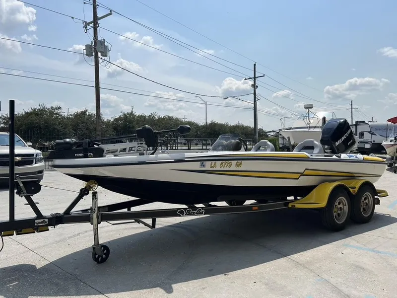 Slide: The Image of 2010 Bass Cat Pantera IV boat on trailer in sunny outdoor setting. - 13