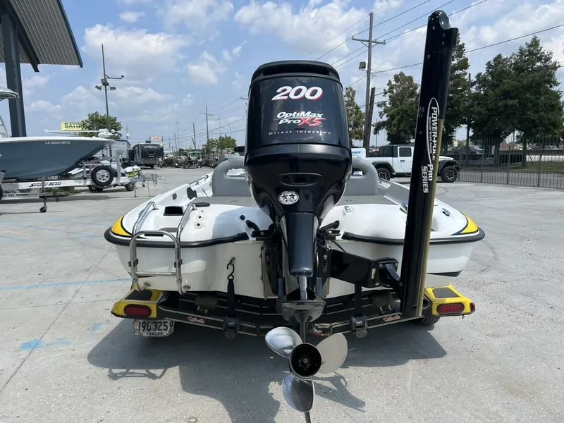 Slide: The Image of 2010 Bass Cat Pantera IV boat with OptiMax Pro XS engine, parked outdoors. - 14