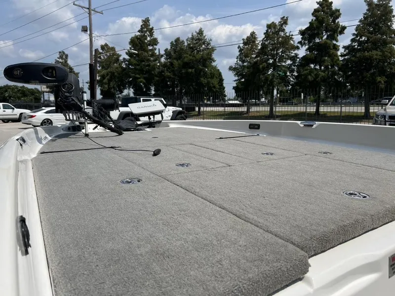 Slide: The Image of 2010 Bass Cat Pantera IV boat deck with fishing equipment, parked outdoors. - 4