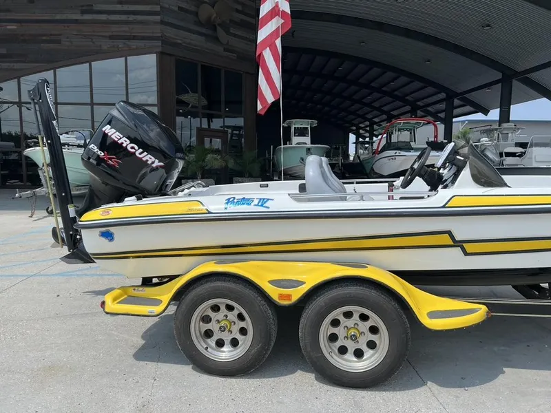 Slide: The Image of 2010 Bass Cat Boats Pantera IV with Mercury engine, parked on a yellow trailer. - 6