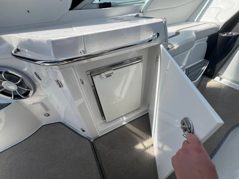 Slide: The Image of 2017 Monterey 355 Sport Yacht interior with open cabinet and speaker. - 17