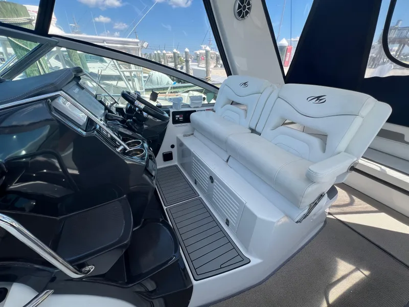 Slide: The Image of Interior of 2017 Monterey 355 Sport Yacht with white seating and modern dashboard. - 20