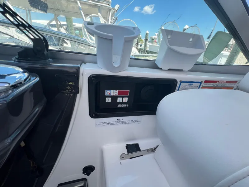 Slide: The Image of 2017 Monterey 355 Sport Yacht dashboard with controls and cup holders. - 23