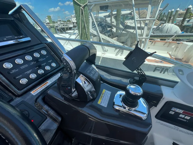 Slide: The Image of Control panel of a 2017 Monterey 355 Sport Yacht with throttle and navigation controls. - 25