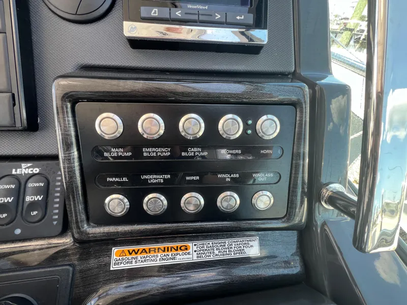 Slide: The Image of Control panel of a 2017 Monterey 355 Sport Yacht with various switches and warning label. - 26