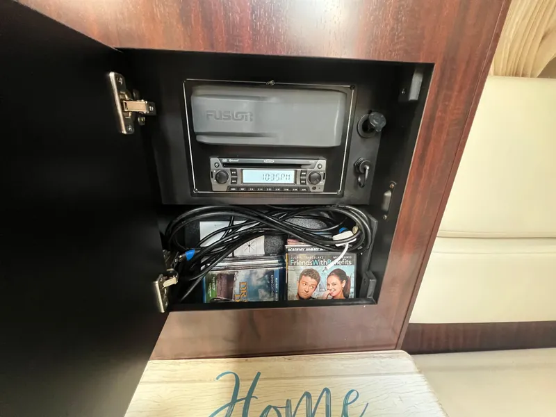 Slide: The Image of Stereo system and DVDs in 2017 Monterey 355 Sport Yacht cabinet. - 42