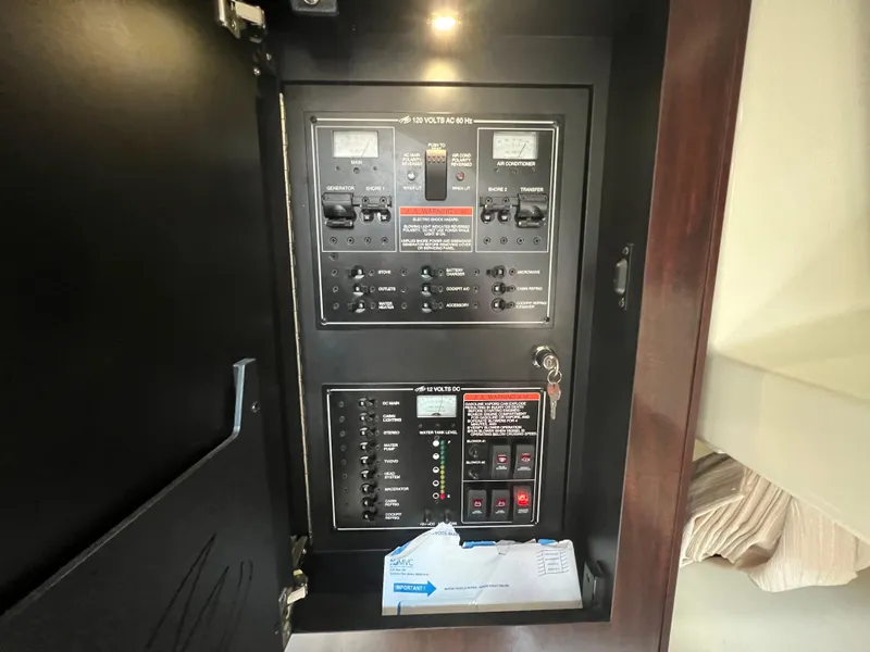Slide: The Image of Electrical control panel inside 2017 Monterey 355 Sport Yacht, featuring switches and gauges. - 43