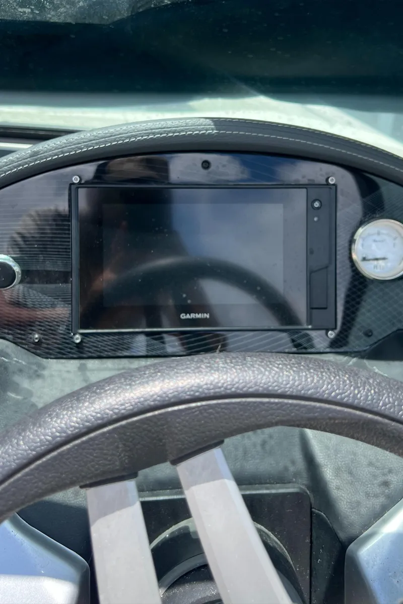 Slide: The Image of 2021 Regal 21 OBX dashboard with Garmin display and gauge. - 11