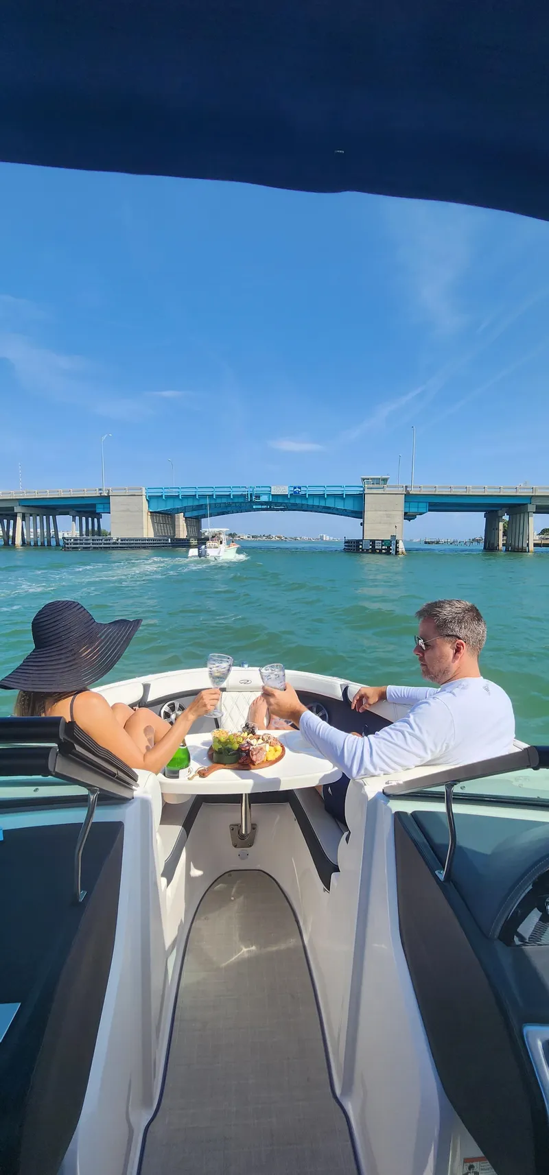 Slide: The Image of Couple dining on 2021 Regal 21 OBX boat, enjoying scenic water view. - 17