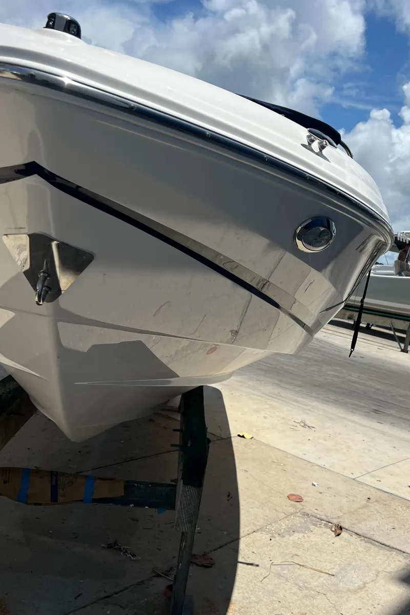 Slide: The Image of 2021 Regal 21 OBX boat on trailer, sunny day, blue sky. - 2