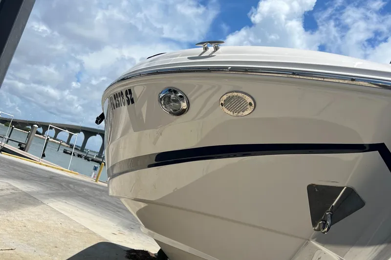 Slide: The Image of 2021 Regal 21 OBX boat docked under a bright blue sky. - 4