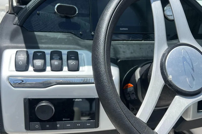 Slide: The Image of 2021 Regal 21 OBX boat dashboard with steering wheel and control panel. - 7