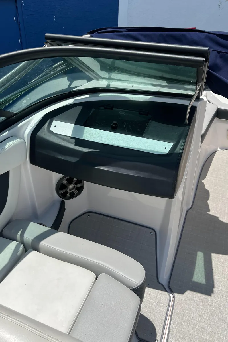 Slide: The Image of 2021 Regal 21 OBX boat interior with seating and dashboard. - 8