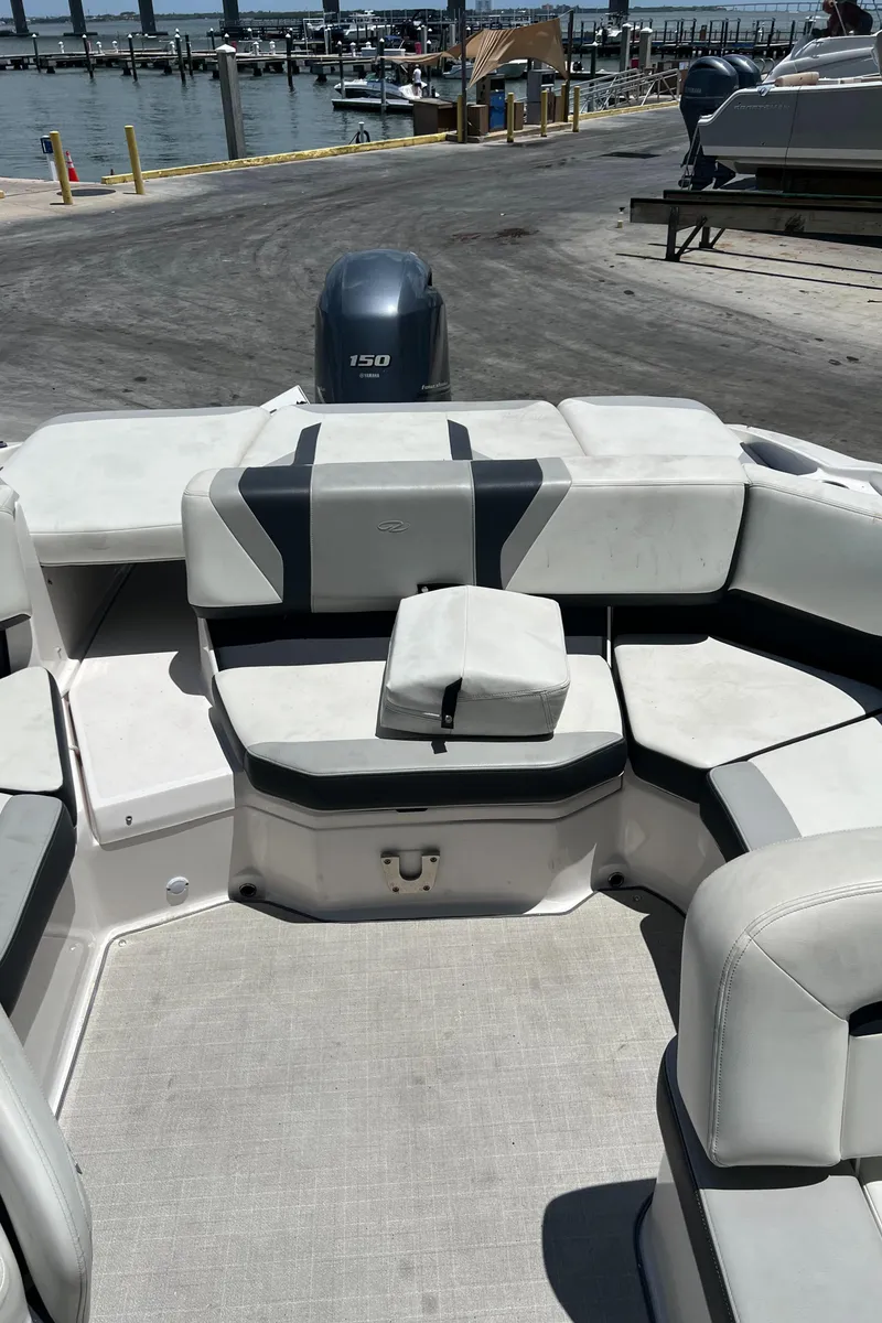 Slide: The Image of 2021 Regal 21 OBX boat interior with seating, dockside view. - 9
