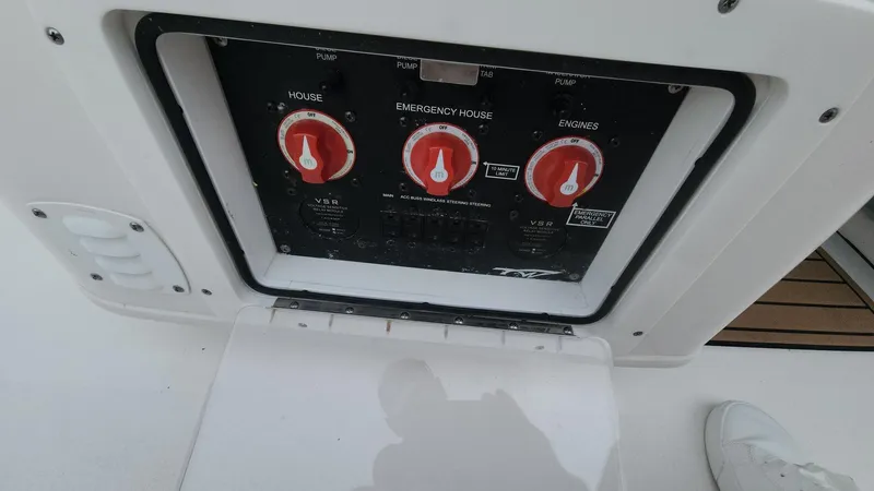 Slide: The Image of Control panel of 2024 Tidewater 2700 Carolina Bay boat with battery switches. - 11