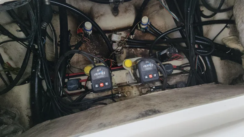 Slide: The Image of Engine compartment of 2024 Tidewater 2700 Carolina Bay with wiring and components visible. - 19