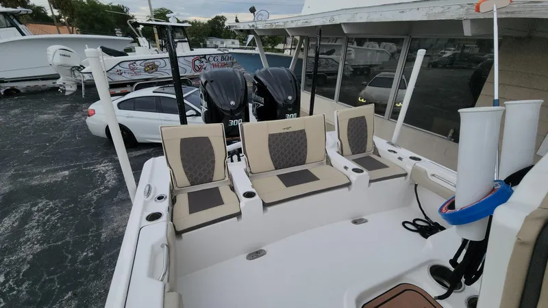 Slide: The Image of 2024 Tidewater 2700 Carolina Bay boat with dual Yamaha engines, docked at a marina. - 22