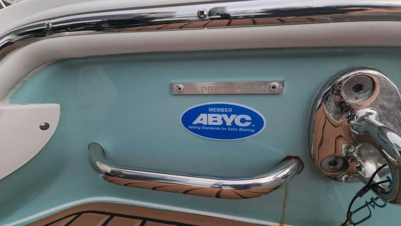Slide: The Image of 2024 Tidewater 2700 Carolina Bay boat with ABYC member sticker and chrome details. - 29