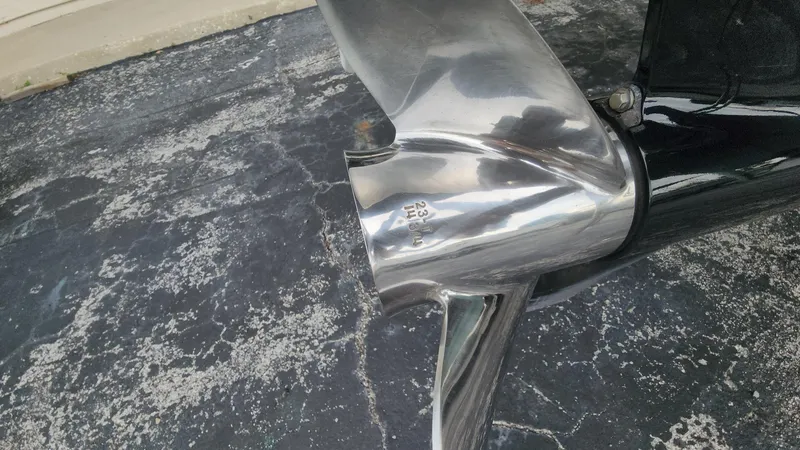 Slide: The Image of Close-up of a 2024 Tidewater 2700 Carolina Bay boat propeller on textured surface. - 31